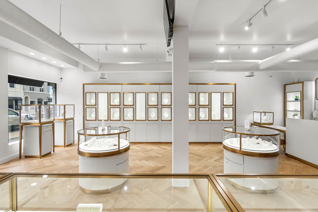 Elegant jewelry store interior featuring sleek display cases and stylish lighting.