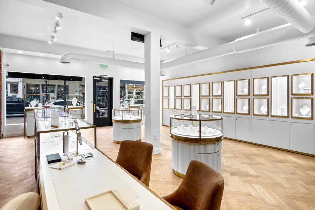 Modern jewelry store interior with elegant display cases and stylish seating.