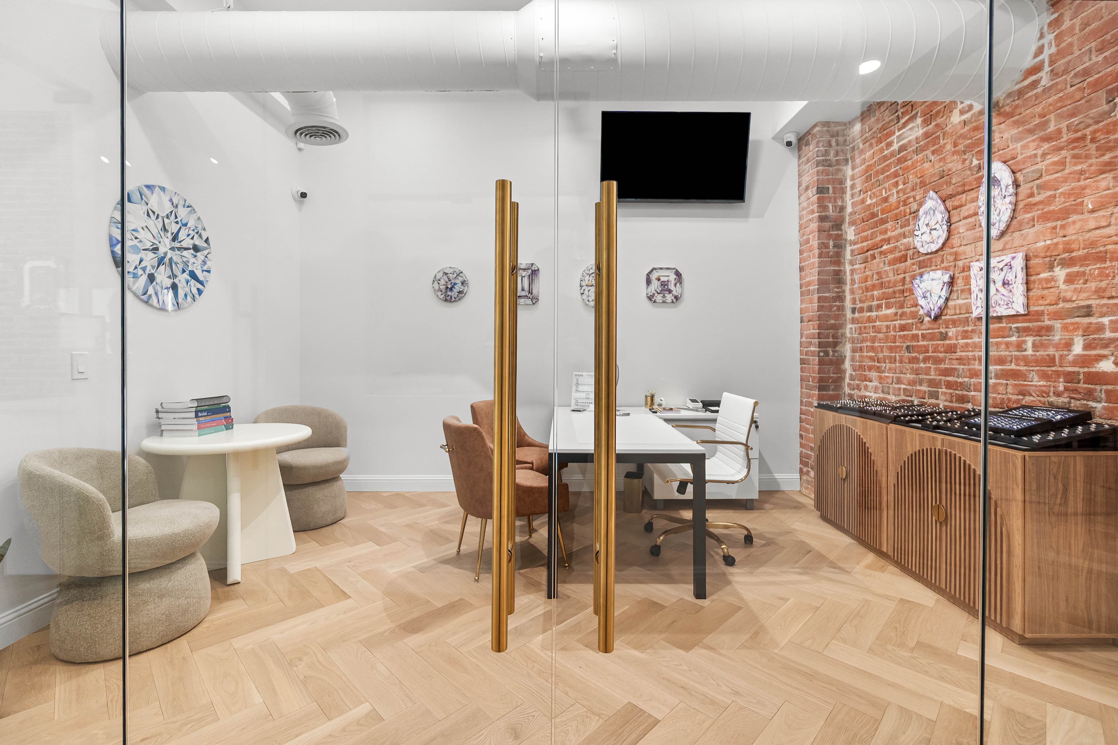 Modern office interior with glass walls, wooden accents, and stylish seating arrangements.